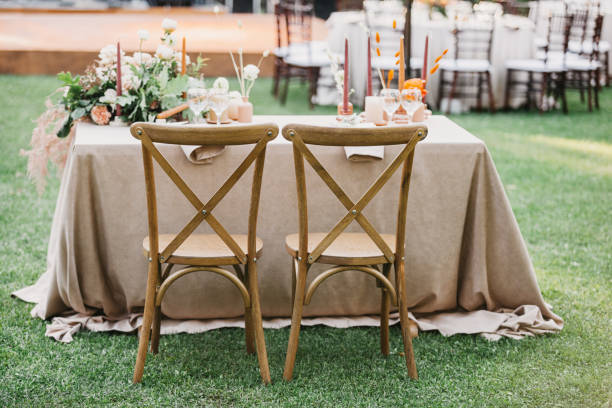 istock Rustic wedding set, vintage dining table with decorations, flowers, boho style, event, party or wedding 1305368570