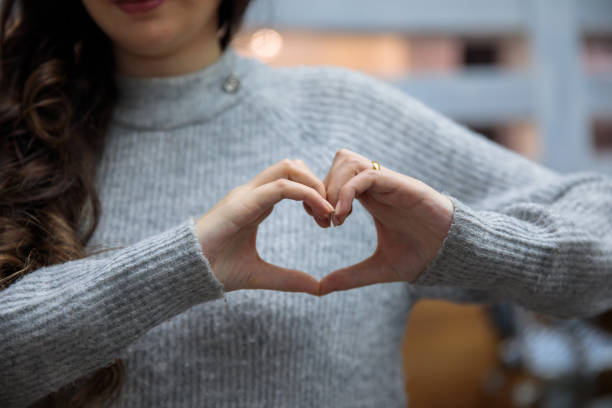 istock woman hand heart sign 1305371601
