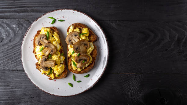 istock Scrambled eggs French toast with mushrooms, Top view, banner, overhead 1305373200