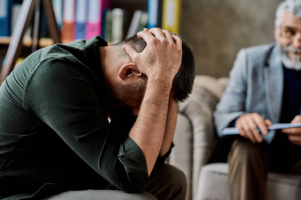 istock Depressed caucasian man listening to psychotherapist 1305374517