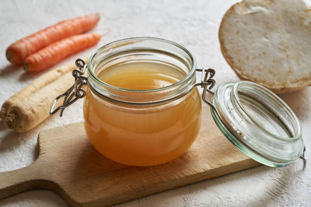 istock Bone broth in a glass jar on a white background 1305376507