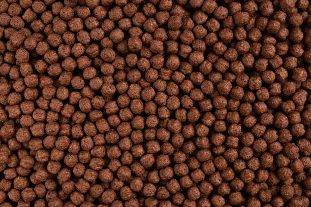 istock Chocolate breakfast cereal texture. Cereal balls as background. Top view. 1305377150