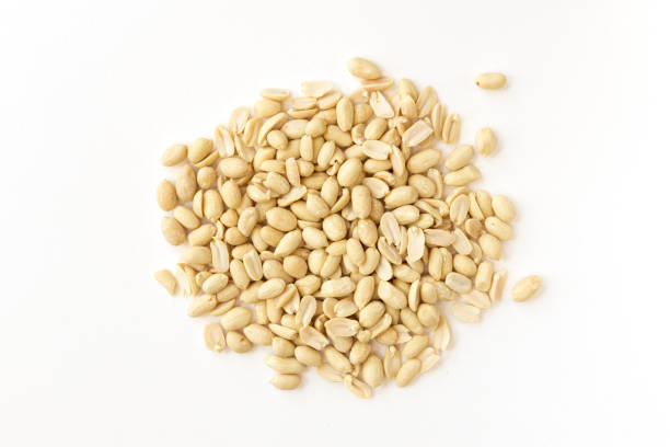 istock Arranged peanuts peeled and isolated on white background. 1305377358