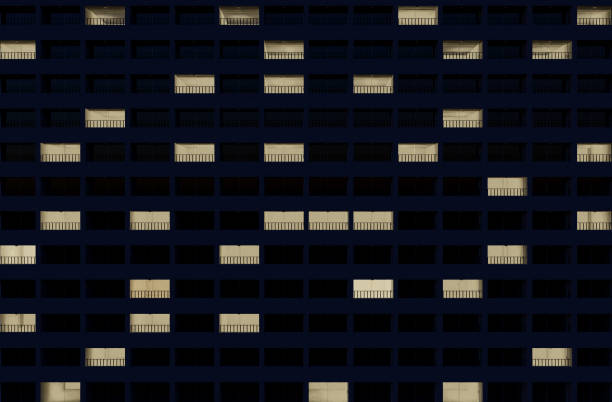 istock building facade at night with some rooms illuminated 1305382012