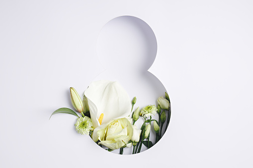 Number 8 with fresh gerbera, calla and rose flowers with green leaves on bright white background
