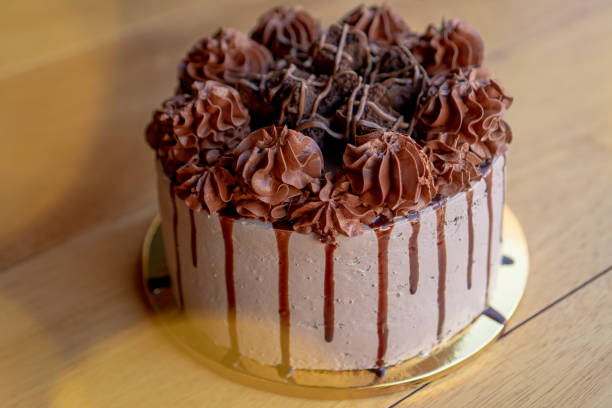 istock Exquisite chocolate cake with chocolate cream and brownies on top. 1305383693