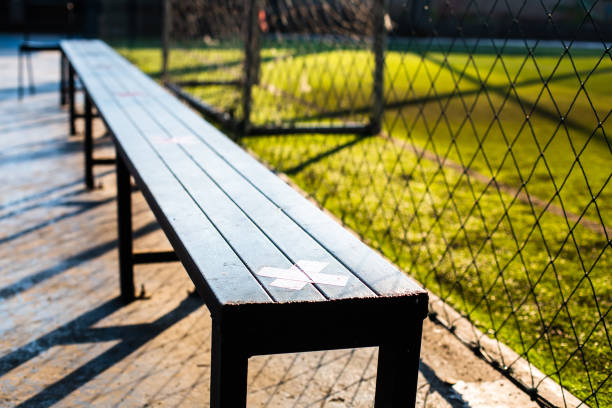 Selective focus to Sitting marker for social distancing in soccer field. Measures to prevent COVID-19 infection in football stadiums.