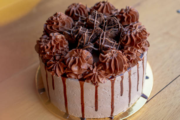 istock Exquisite chocolate cake with chocolate cream and brownies on top. 1305384528