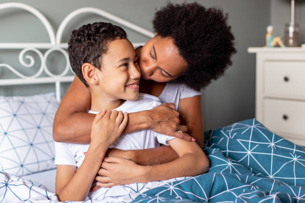 istock Woman and her son in bed, waking up 1305385056