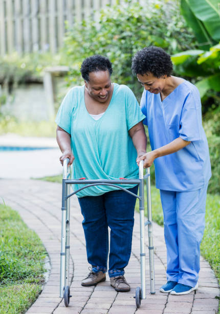 istock Senior woman with mobility walker assisted by nurse 1305385091