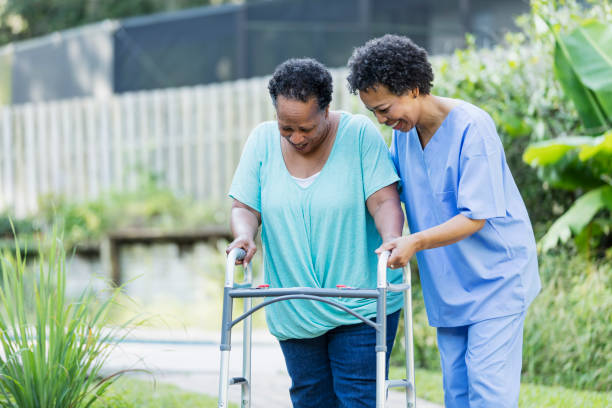 istock Senior woman with mobility walker assisted by nurse 1305385388