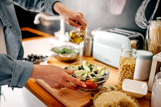Preparing a healthy salad in the kitchen, lots of vegetables