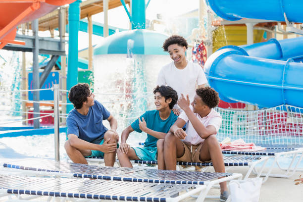 Four teenage boys having fun at water park