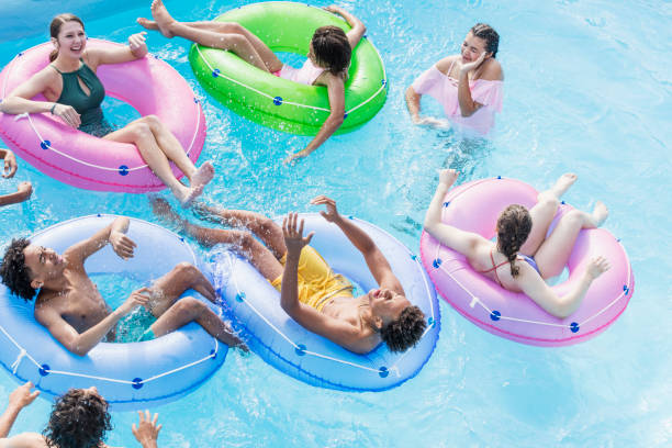 istock Teenagers at water park playing in lazy river 1305387431