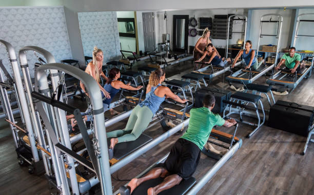 istock Three adults in Pilates studio with fitness instructor 1305387531