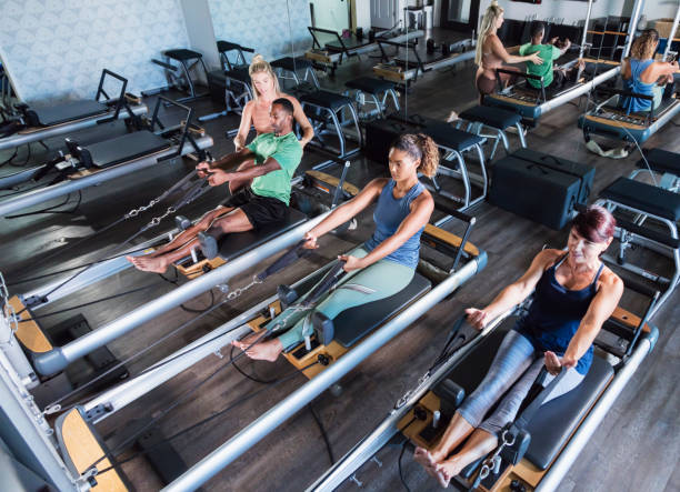 istock Three adults in Pilates studio with fitness instructor 1305387658
