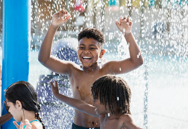 istock Boy with friends at water park 1305388458