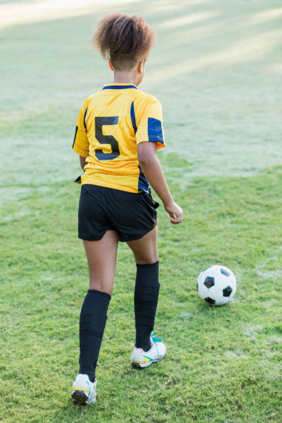 istock Girl playing soccer 1305388584