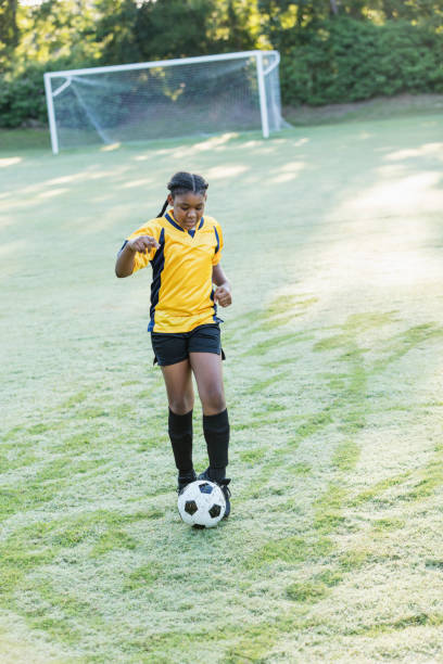 istock Girl playing soccer 1305388608