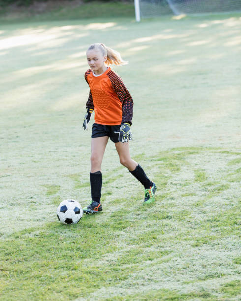 istock Girl playing soccer 1305388663