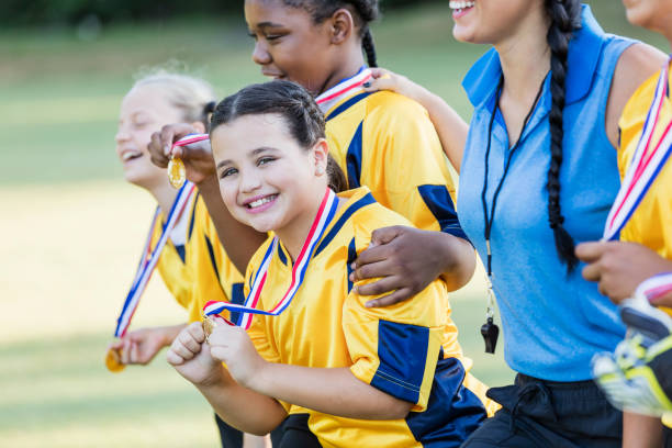 istock Hispanic girl on winning soccer team 1305388775