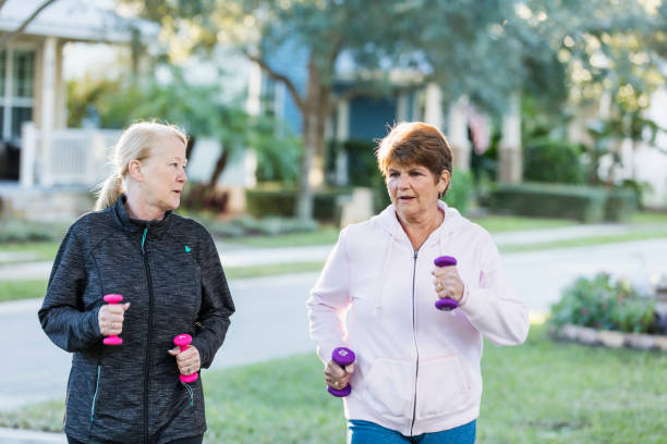 istock Two senior women walking with hand weights 1305390185