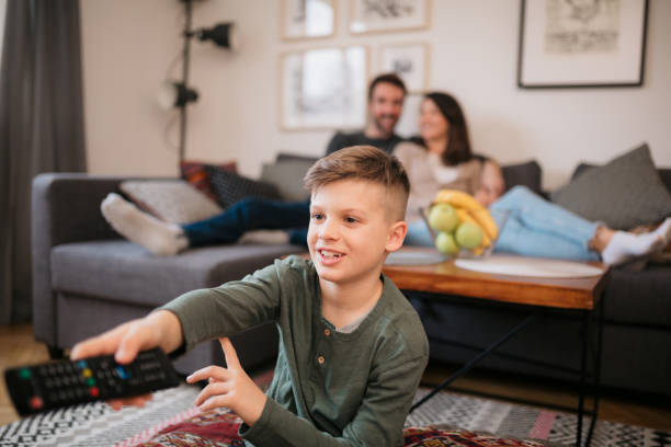 istock Happy Caucasian boy watching TV at home 1305390366