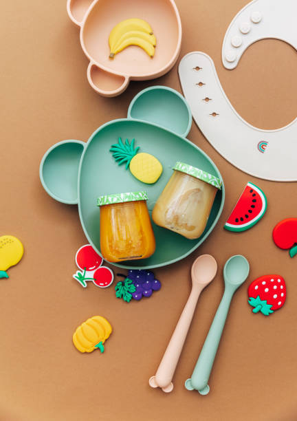 istock Bright silicone dishware on light background. Serving baby, first feeding concept. Flat lay, copy space, top view 1305394582