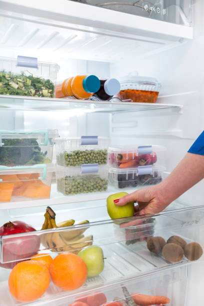 istock A woman taking green apple into fridge 1305394779