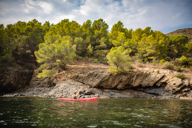 istock Spanish Male Kayaker Paddling Along Rocky Coastline 1305403256