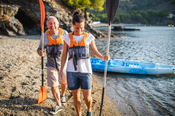 istock Lighthearted Spanish Kayakers Laughing on Beach 1305403280