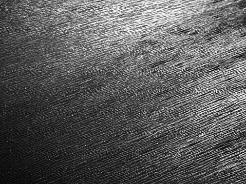 Dark grunge texture on old wooden board with scattered black spots for background