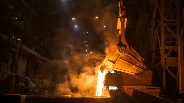 Tank pours liquid metal in the molds at the steel mill. Cinemagraph.