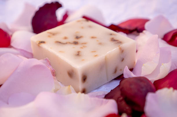 istock Handmade rose soaps decorated with rose petals on a white background. 1305406138