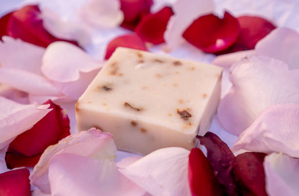 istock Handmade rose soaps decorated with rose petals on a white background. 1305406248