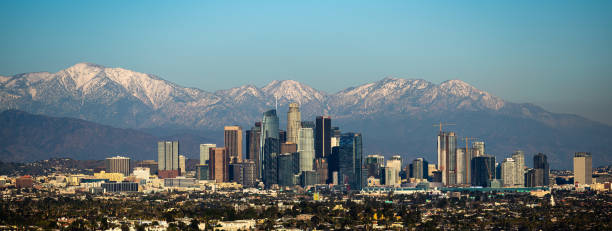 Downtown Los Angeles with snow capped mountains in background. City in front of mountains. city of los angeles stock pictures, royalty-free photos & images