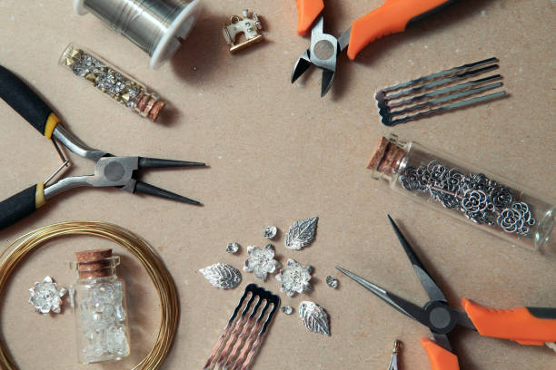 istock Tools for creating jewelry. Beads, crystals, glass bottles with cork lids, hair combs. Wire, cutters, pliers. 1305407127