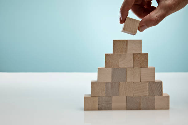 istock Blocks on Blue Background symbolizing Business Growth 1305410175