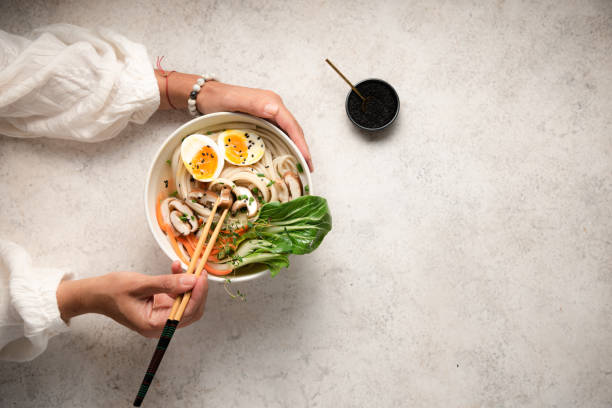 Flat lay of noodle bowls with hands Flat lay of noodle bowls with hands japanese food stock pictures, royalty-free photos & images