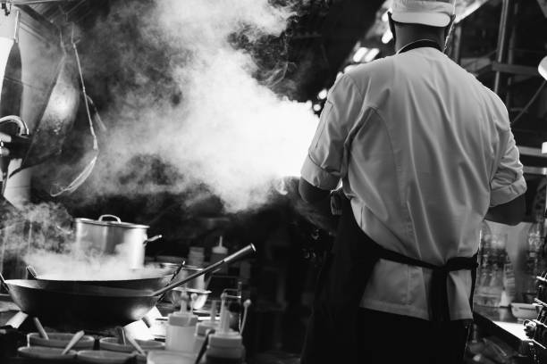 istock Chef stir fry busy cooking 1305416786