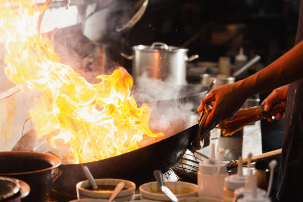 istock Chef stir fry busy cooking 1305416792