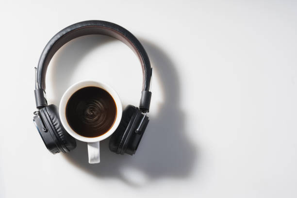 istock Headphones and coffee cup on white background 1305416810