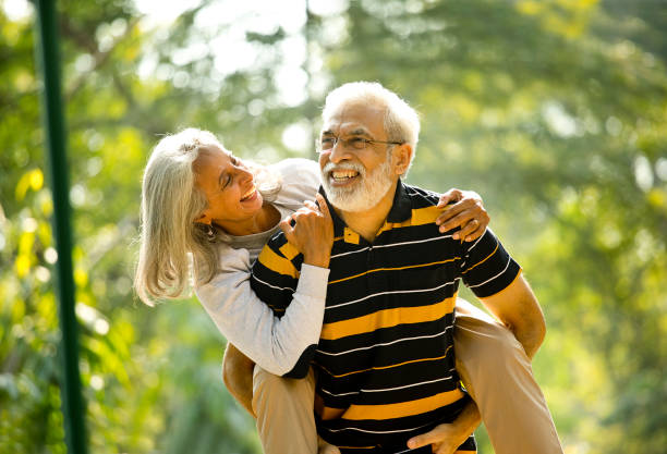 istock Senior man piggybacking his wife 1305419336