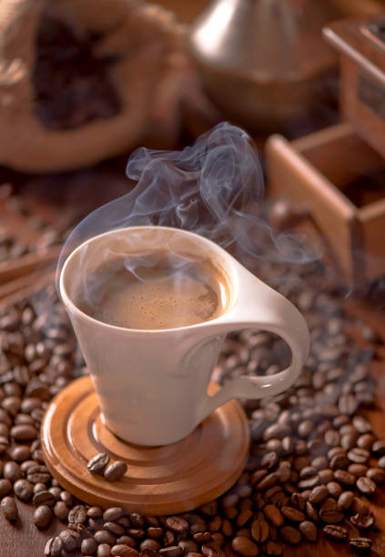 istock cup of coffee and coffee beans in a sack on dark background, top view 1305420247
