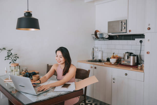istock Asian chinese beautiful woman smiling online studying the kitchen using laptop 1305420382