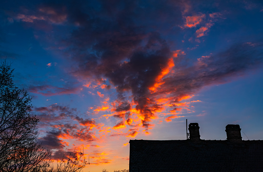 Bright colorful dawn over the roof of a house