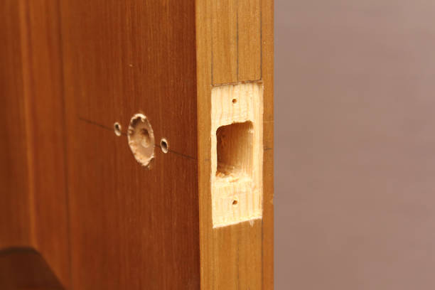 istock Close-up end hole for door latch inserting. Markup for doorknob installing. 1305424711