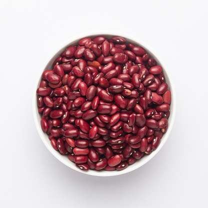 Close up of Organic Rajma,  (Laal Lobia ) or red kidney beans dal on a ceramic white bowl. Top view