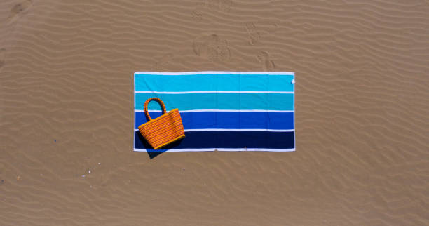 sand and beach towel- vacation, holiday, relax concept