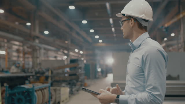 SLO MO Employee using a digital tablet in a manufacturing plant